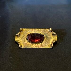 Vintage brass pin with faceted purple stone